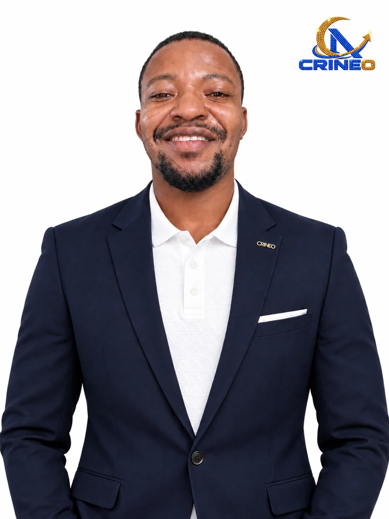 Christopher in a navy suit with a gold CRINEO lapel brooch